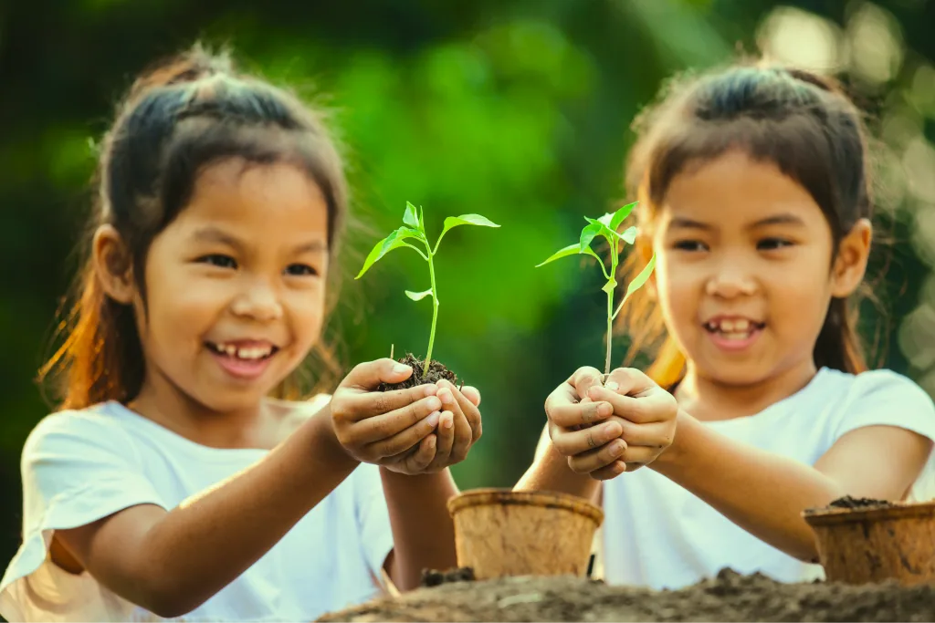 Children learning to care for a seedling